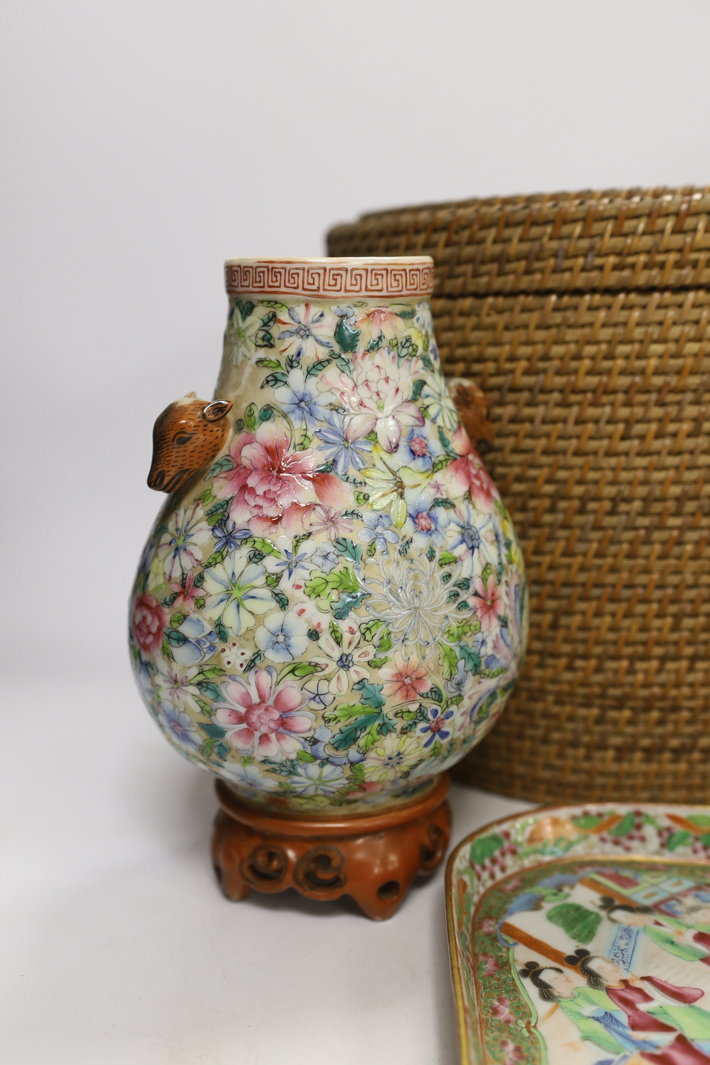Two Chinese enamelled porcelain Millefleur vases, one with Qianlong Mark, both late 19th/early 20th century, together with two Chinese famille rose dishes and a similar basket cased tea kettle